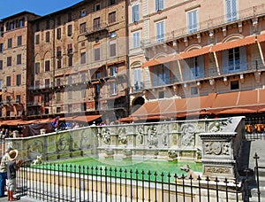 The Fonte Gaia in Piazza del Campo, his characters are a document of the early Renaissance sculpture. Siena, Tuscany