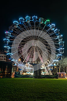 Fonte Nova`s garden with Christmas market and colored ferris wheel near Ria de Aveiro at night