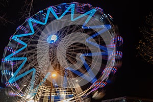 Fonte Nova`s garden with Christmas market and colored ferris wheel near Ria de Aveiro at night