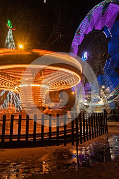 Fonte Nova`s garden with Christmas market and colored ferris wheel near Ria de Aveiro at night