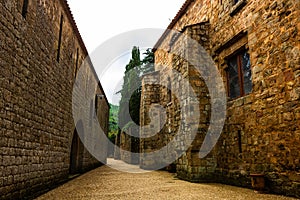 Fontfroide Abbey monastery in France. Empty alley with brick walls