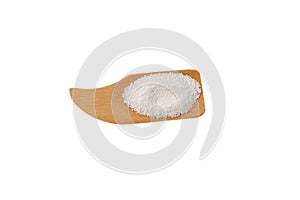 Food additive E211 on wooden scoop, isolated on white, top view. Sodium benzoate, sodium salt of benzoic acid. White crystalline