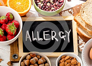 Food allergy. Allergic food on wooden background.