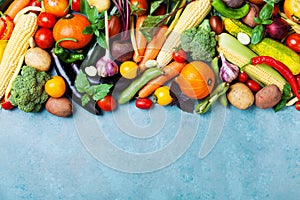 Food background with autumn farm vegetables and root on blue table top view. Healthy and organic harvest.