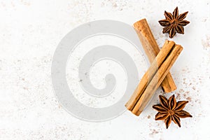 Food Background with Ceylon Cinnamon Sticks and Star Anise on White Speckled Background