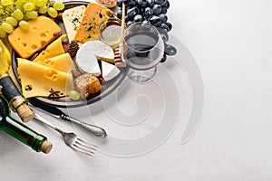 Food background with cheese. Blocks of moldy cheese, grapes, honey, nuts over on white background. Copy space.