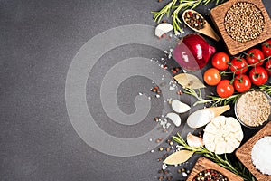 Food background with copy space - variety of seasonings, herbs, spices in wooden bowls and vegetables