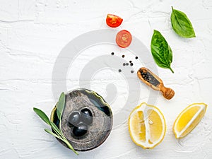 Food background with fresh herbs tomato ,lemon slice , black pe