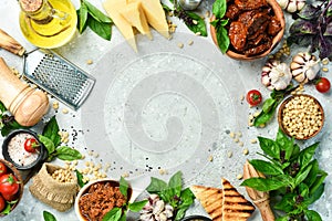 Food background. Fresh vegetables, spices, basil, cheese and spices. On a concrete background.