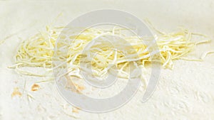 Food background. Grate cheese on pita bread