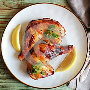 Food background. Grilled chicken leg quarters with crispy golden brown skin