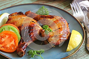 Food background. Grilled chicken leg quarters with crispy golden brown skin