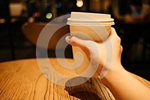 Food background hand of woman holding coffee glass in restaurant