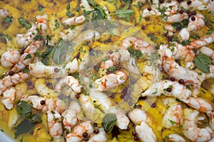 Food background of lots of cooked italian prawns in olive oil