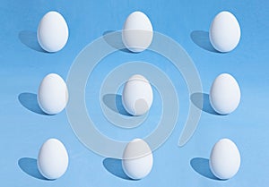 Food background made of white Easter eggs on a blue backdrop