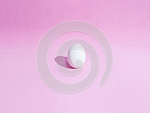 Food background made of white Easter eggs on a pink backdrop.