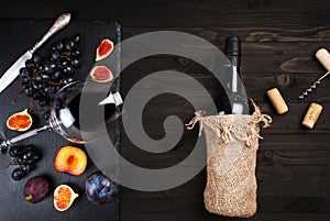 Food background with red wine, figs, grapes and cheese