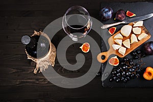 Food background with red wine, figs, grapes and cheese