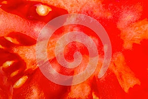 Food background. Slice of fresh red tomato. Detailed macro shot. Top view