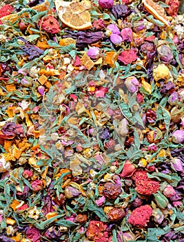 Food background texture of green tea with flower rose petals and fruit pieces, organic healthy herbal leaves, detox tea