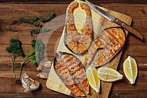 Food background of three pieces of black pepper salom steak on wooden board and wooden table