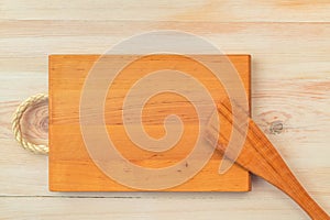 Food background. Top view of empty wooden cutting board and spatula on planks vintage table with copy space