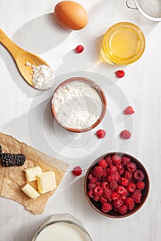 Food background top view. Mock up with ingredients for cooking pie or pancake on white background. Vertical. Summer berry. honey,