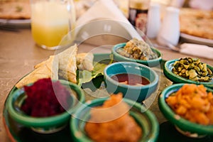 Food background traditional Moroccan salads served on tagine dishes on green ceramic plate. Moroccan culture, cuisine