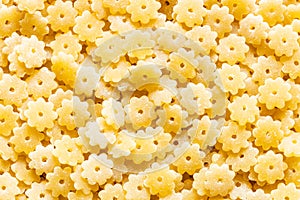 Food background from uncooked stelle pasta pieces photo