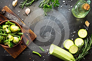 Food background.Various summer green vegetables, spices, olive oil and fresh herbs