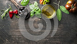 Food background with vegetables, herbs and condiment. Greek black olives, fresh basil, sage, rosemary, tomato, peppers photo