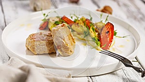 Food banner. Appetizing poultry cutlets and grilled vegetables on a white plate. Grilled zucchini and carrots with herbs