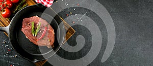 Food banner. Raw meat in black cast-iron pan. Top view, copy space