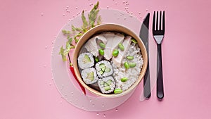 Food banner. Rolls with cucumber, boiled rice, pork, green beans. Asian cuisine fast food delivery. Cardboard bowl, disposable