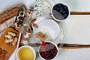 Food banner - Two toasts or bruschetta with blueberries and cranberries on cream cheese camembert, DorBlu, salty blue cheese nuts,