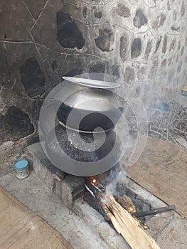 Food being cooked in a pot in traditional style in a village in Rajasthan