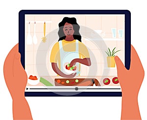 Food blogger is on laptop display. Culinary video broadcast or channel  with cooking online class. Young woman preparing salad in