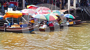 Food boat with colorful umbrella at Ampawa