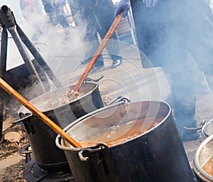 Food in bowlers on bonfire, cooking outdoor in a traditional style