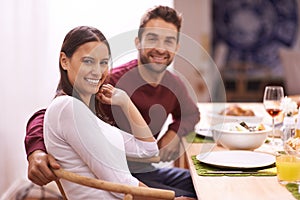 Food brings everyone together. A happy couple enjoying a family meal around the table.