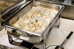 Food buffet self service lunch or dinner with quality fish filet slices in sauce in stew