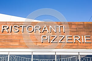 Food, cafe and signboard concept - Pizzeria sign on restaurant