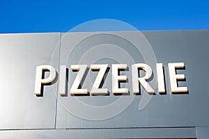 Food, cafe and signboard concept - Pizzeria sign on restaurant