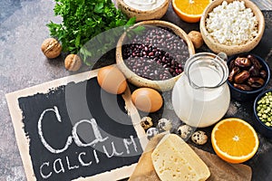 Food with calcium. A variety of foods rich in calcium. Signboard with the word-calcium. Top view.