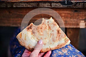 Food of the Caucasian Georgian kitchen,, a girl holds pieces in hands. Piece of pita bread in hand