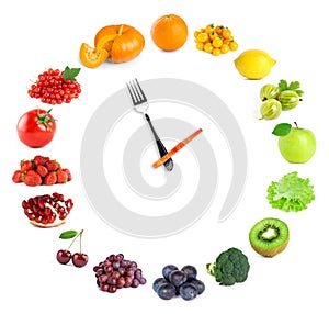 Food clock with fresh fruits and vegetables on white