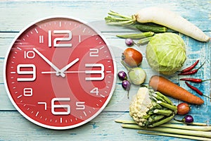 Food clock. Healthy food concept on wooden table