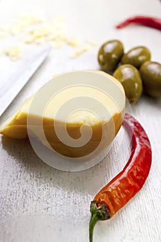 Food composition of chili pepper, green olives and cheese.