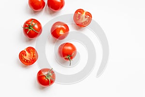 Food composition of many fresh ripe red tomatoes on a white background with copy space