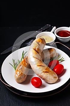 Food concept Grilled BBQ White sausages on black background with copy space